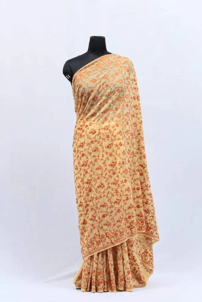 Fawn Color Kashmiri Work With Bright  Thread Embroidery Saree Enriched With All Over Running Jaal Gives Rich Look.